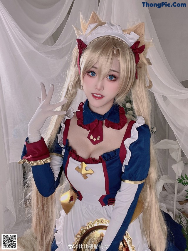 A woman in a blue and white dress with a cat ears headband.