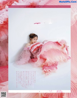 A young girl holding a teddy bear in front of her face.