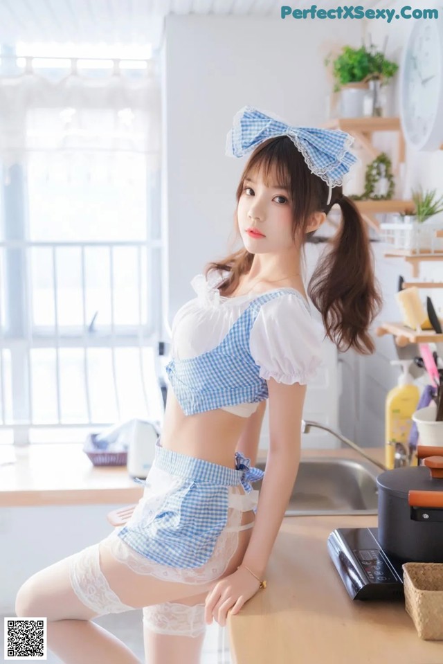 a woman in a blue and white outfit posing for a picture