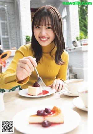 A woman sitting at a table with a tray of food.