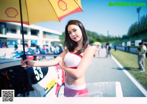 A woman in a white and red bikini posing for a picture.