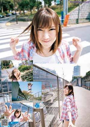 A young woman sitting on a ledge in front of a construction site.