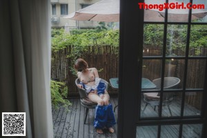 A naked woman sitting in a bathtub in a bathroom.